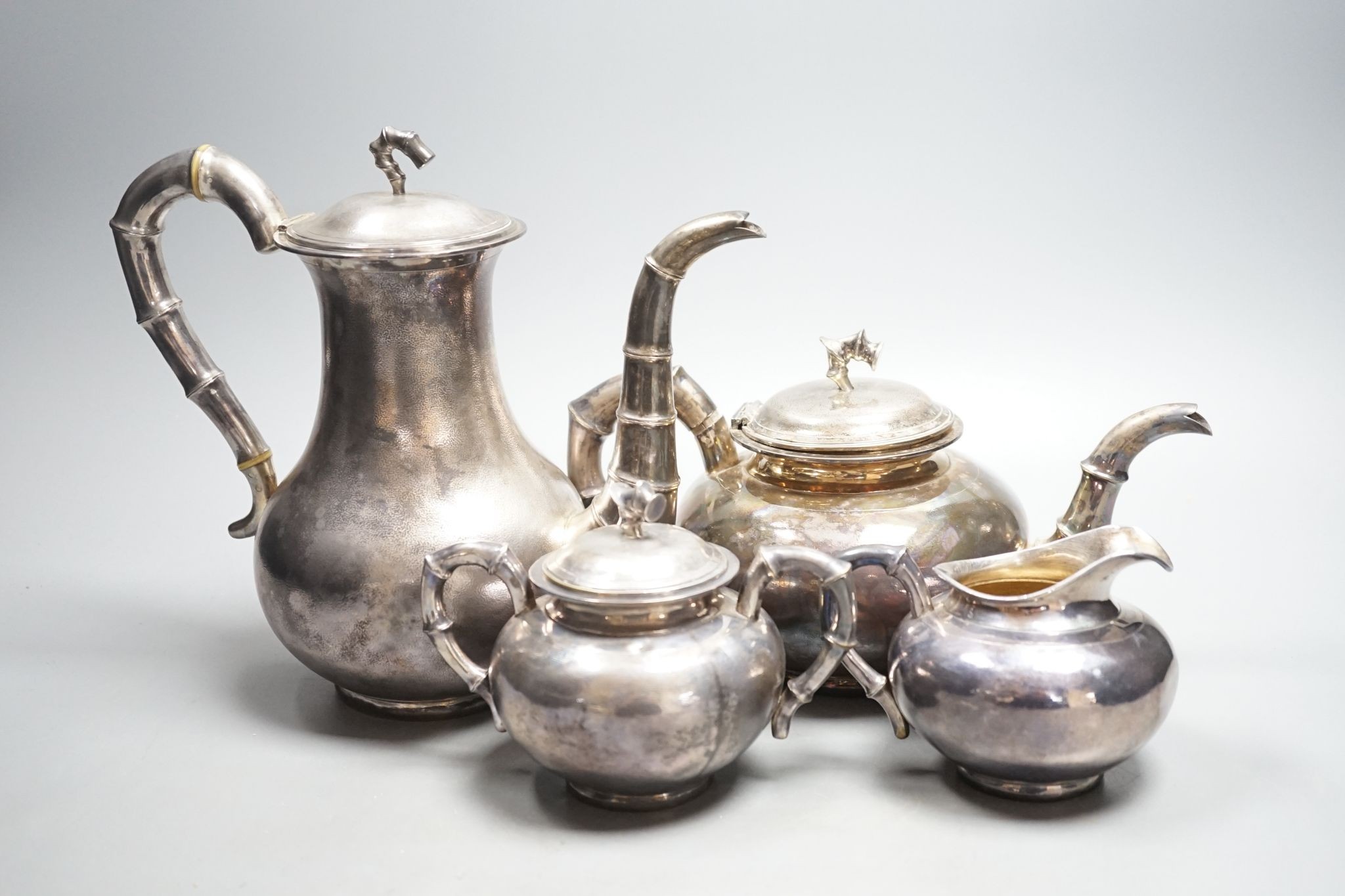 An early 20th century Chinese Export planished white metal four piece tea and coffee set, with faux bamboo handles, by Zee Wo, gross 44oz.